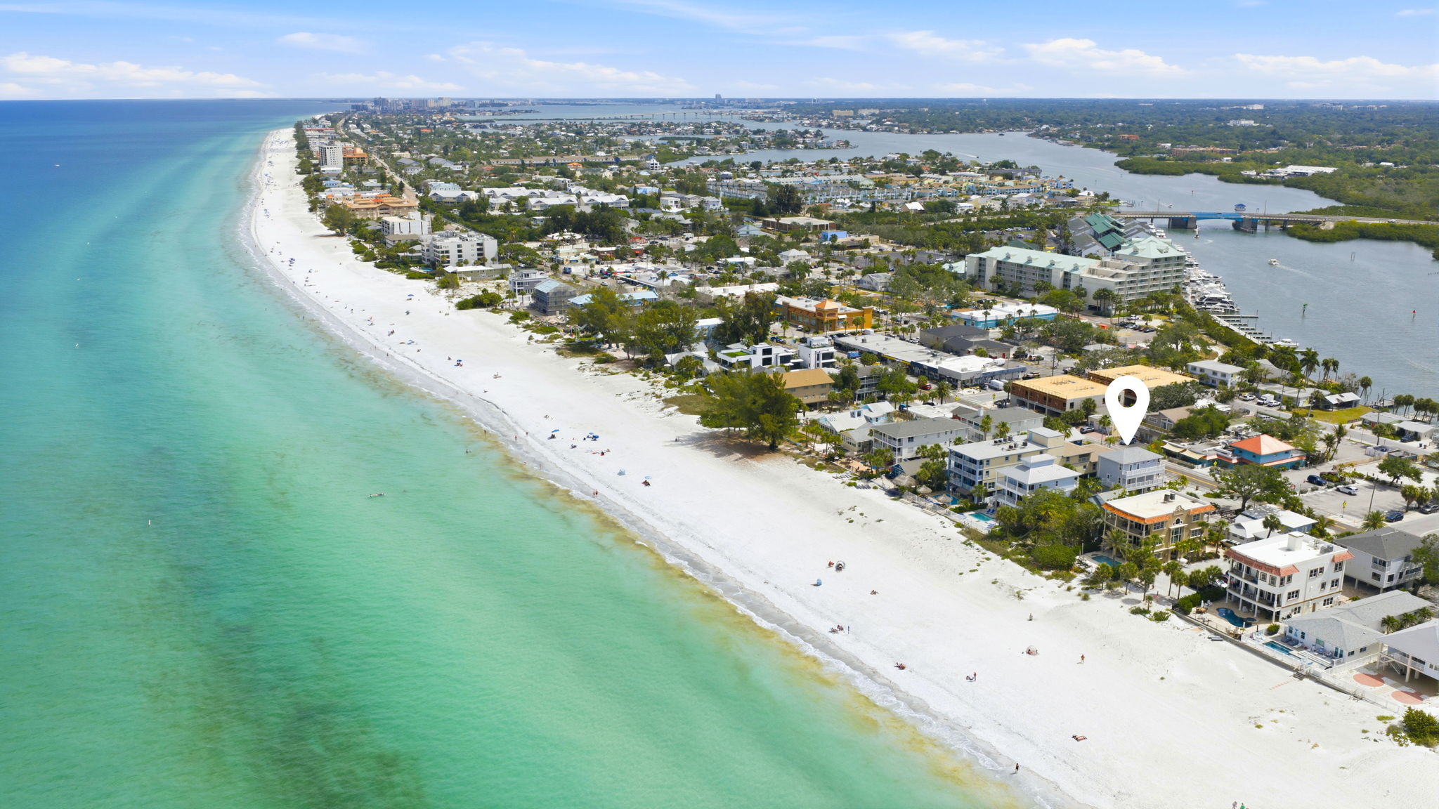 Aerial view of Indian Rocks Beach Florida barrier island community showing white sand Gulf of Mexico beach, beachfront short-term rental properties, and Gulf Beach corridor in Pinellas County