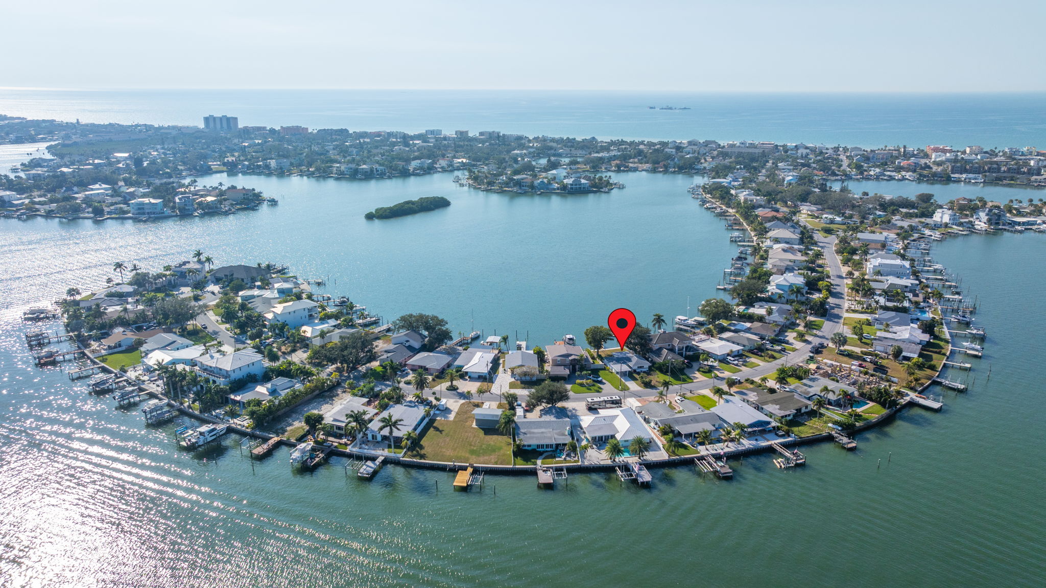 Aerial view of Indian Rocks Beach Intracoastal lagoon with Gulf of Mexico visible in background showing the complete water ecosystem surrounding this Pinellas County barrier island STR investment market including canals waterways and residential neighborhoods