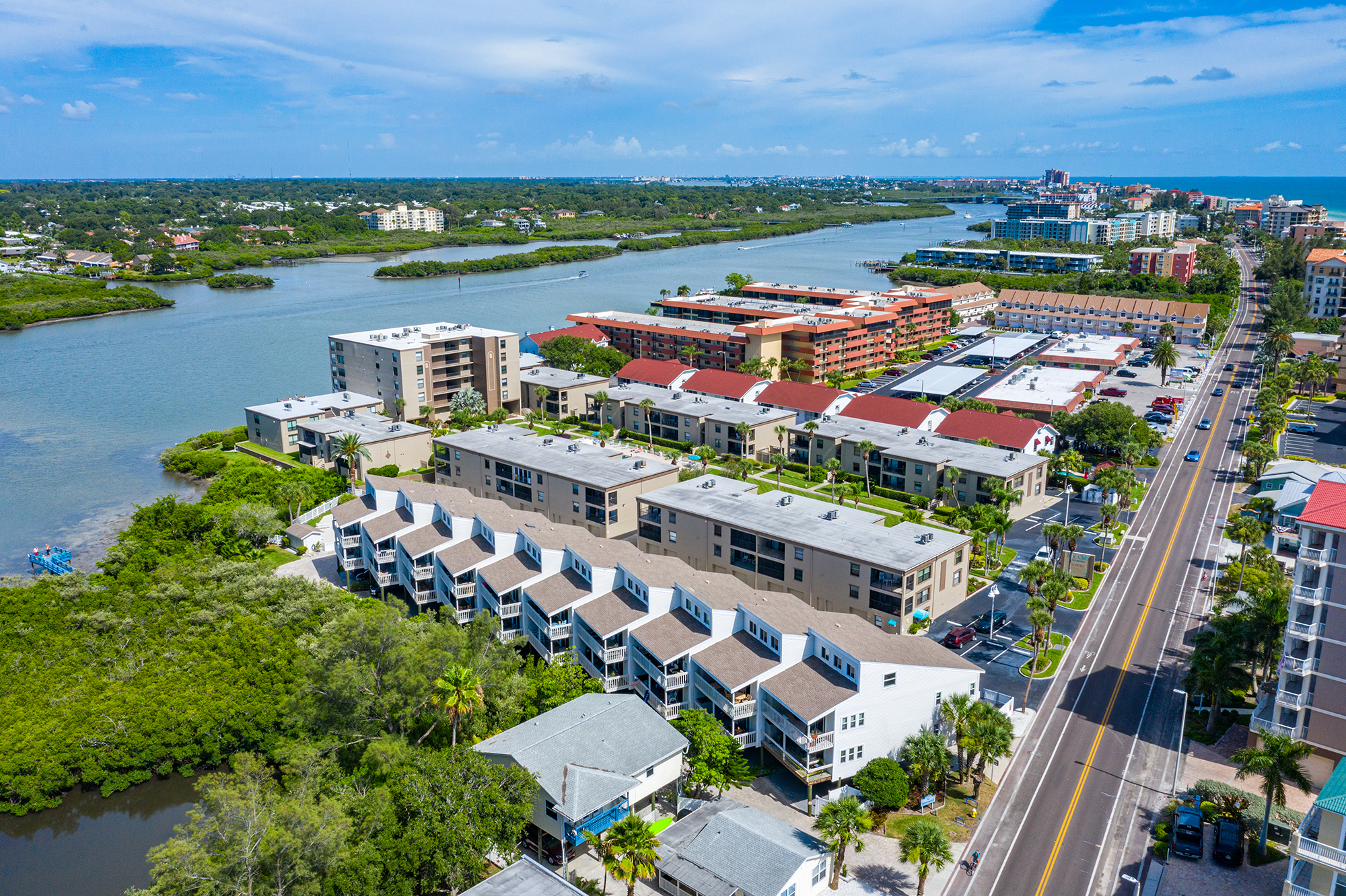 Aerial view of Intracoastal Waterway side condo buildings along Gulf Boulevard in Indian Shores Florida showing the waterway and multiple condo buildings short-term rental investment properties Pinellas County