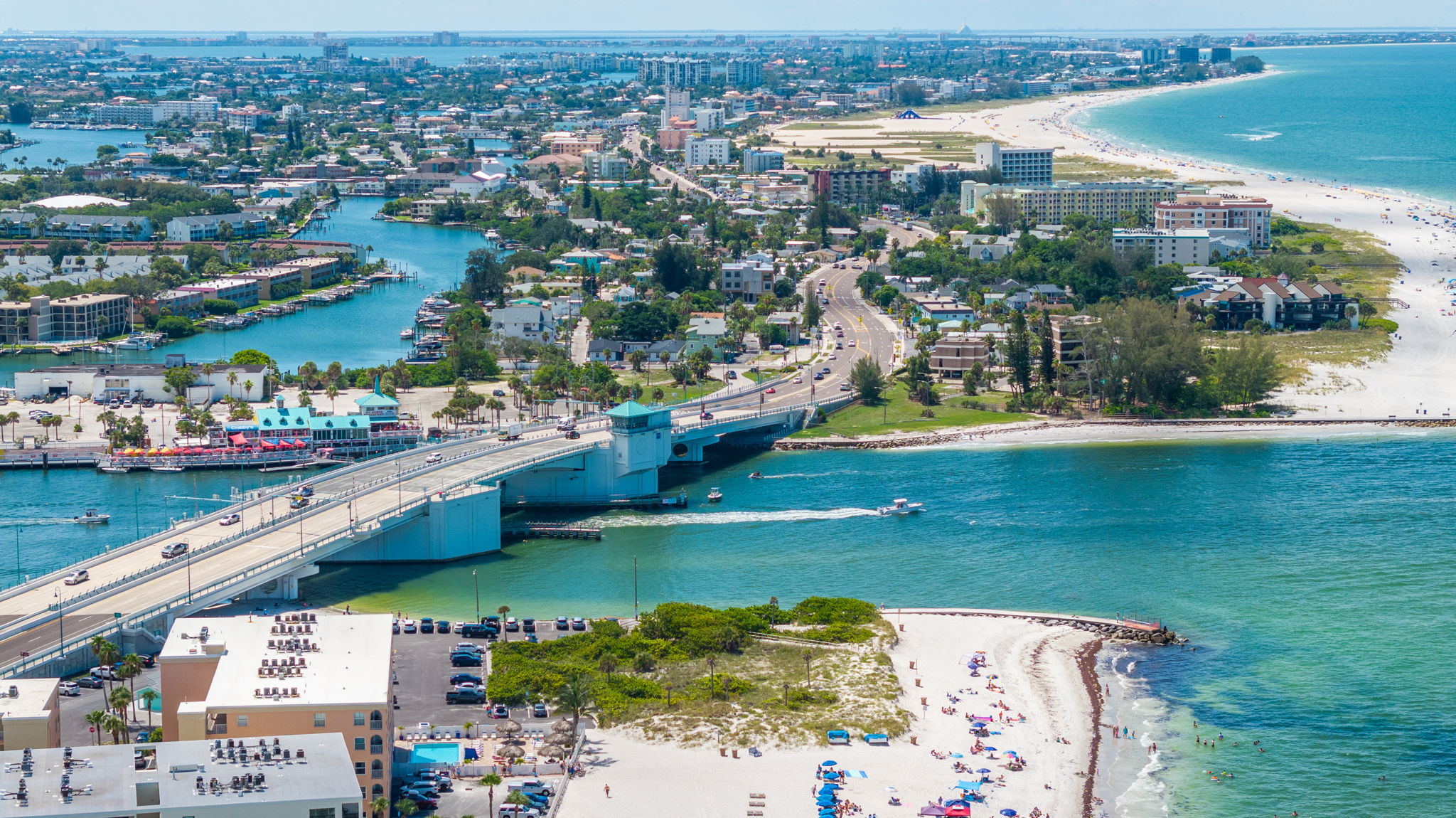 Aerial view of John's Pass inlet drawbridge Madeira Beach Florida showing direct Gulf of Mexico water access for boaters - vacation rental and STR investment market Pinellas County